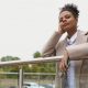 portrait of a serious pensive black young woman looking longingly into the distance.